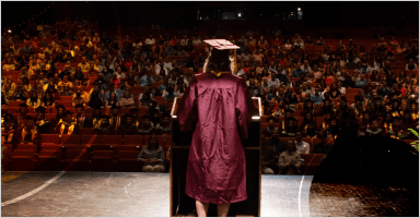 A graduate is giving speech to a crowed
